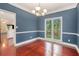 Inviting dining room featuring cherry floors, elegant lighting, and a sunny window at 300 Wesfork Nw Way, Suwanee, GA 30024