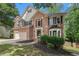 Traditional two-story home with brick facade, neat landscaping, and an inviting front entrance at 300 Wesfork Nw Way, Suwanee, GA 30024