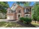 Beautiful two-story brick home with well-maintained landscaping and a two-car garage, set in a lush, green environment at 300 Wesfork Nw Way, Suwanee, GA 30024