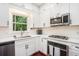 Kitchen featuring white cabinetry, stainless appliances, and modern countertops at 300 Wesfork Nw Way, Suwanee, GA 30024