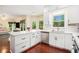 Modern kitchen with stainless steel appliances, white cabinetry, and marble countertops at 300 Wesfork Nw Way, Suwanee, GA 30024