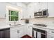 Well-appointed kitchen with stainless appliances and white cabinetry at 300 Wesfork Nw Way, Suwanee, GA 30024