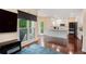 Open-concept kitchen with white cabinets and a center island, seamlessly connected to the living area at 300 Wesfork Nw Way, Suwanee, GA 30024