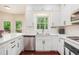 Bright kitchen with white cabinets, stainless appliances and stone countertops at 300 Wesfork Nw Way, Suwanee, GA 30024