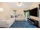 Cozy living room with a comfortable sectional sofa, a fireplace, and a large screen TV, perfect for relaxation at 300 Wesfork Nw Way, Suwanee, GA 30024