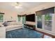 Bright living area with a fireplace, large windows offering backyard views, and modern furnishings at 300 Wesfork Nw Way, Suwanee, GA 30024