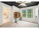 Home office with custom built-in desk and shelves, a whiteboard, and large picture window at 300 Wesfork Nw Way, Suwanee, GA 30024