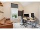 Well-lit home office with modern desk and comfortable seating at 300 Wesfork Nw Way, Suwanee, GA 30024