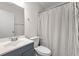 Clean bathroom with modern vanity, toilet, and shower with a striped curtain at 3723 Glenwood Rd, Decatur, GA 30032