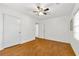 Bright bedroom featuring wood floors, a ceiling fan, and a window for natural light at 3723 Glenwood Rd, Decatur, GA 30032