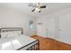 Comfortable bedroom with hardwood floors, ceiling fan and a window at 3723 Glenwood Rd, Decatur, GA 30032