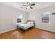 Cozy bedroom with hardwood floors and two windows for natural light at 3723 Glenwood Rd, Decatur, GA 30032