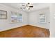Bright bedroom featuring hardwood floors, ceiling fan, and natural light at 3723 Glenwood Rd, Decatur, GA 30032