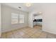 Dining room with neutral tile flooring and a view into the adjacent, updated kitchen at 3723 Glenwood Rd, Decatur, GA 30032