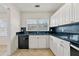 Updated kitchen featuring white cabinets, black countertops, and stainless steel appliances at 3723 Glenwood Rd, Decatur, GA 30032