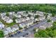 An aerial view shows a neighborhood of townhomes with parking lots and green spaces at 1135 Kilmington Ct, Alpharetta, GA 30009