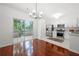 Stylish kitchen with stainless steel appliances and white cabinets, flowing into a dining area at 1135 Kilmington Ct, Alpharetta, GA 30009
