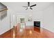 Spacious living room with hardwood floors, fireplace, and a modern ceiling fan at 1135 Kilmington Ct, Alpharetta, GA 30009
