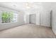 Bright main bedroom with a ceiling fan, a large window, and a big closet at 1135 Kilmington Ct, Alpharetta, GA 30009