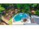 Aerial view of a private backyard featuring a kidney-shaped pool, and brick home at 1348 Timberland Se Dr, Marietta, GA 30067