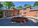 Stunning brick home features a well-manicured backyard, a flower bed, and patio at 1348 Timberland Se Dr, Marietta, GA 30067