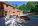 Beautiful backyard with a brick house, a pool and patio furniture at 1348 Timberland Se Dr, Marietta, GA 30067