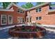 Relaxing backyard patio with brick exterior, classic windows, and a charming circular flower bed at 1348 Timberland Se Dr, Marietta, GA 30067