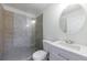Bathroom featuring a tiled shower, vanity with sink, toilet, and round mirror at 1348 Timberland Se Dr, Marietta, GA 30067