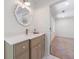 Bright bathroom featuring a vanity with elegant mirror, quartz countertop and shaker cabinets at 1348 Timberland Se Dr, Marietta, GA 30067