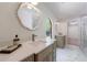 Modern bathroom with double vanity, decorative mirror, and a large, frameless glass shower at 1348 Timberland Se Dr, Marietta, GA 30067