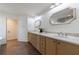 Double sink vanity featuring light wood cabinets and a quartz countertop at 1348 Timberland Se Dr, Marietta, GA 30067