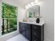Bathroom vanity with a large window and view of the trees at 1348 Timberland Se Dr, Marietta, GA 30067