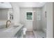 Well-lit bathroom with a sleek vanity, modern fixtures, and a glass-enclosed shower at 1348 Timberland Se Dr, Marietta, GA 30067