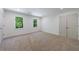 Bright bedroom featuring neutral carpet, fresh white paint, two windows with natural light, and a double-door closet at 1348 Timberland Se Dr, Marietta, GA 30067