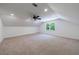 Bright bedroom featuring neutral carpet, a ceiling fan, and a large window at 1348 Timberland Se Dr, Marietta, GA 30067
