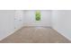 A bright bedroom with neutral carpet, a window with natural light and white doors at 1348 Timberland Se Dr, Marietta, GA 30067
