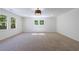 Spacious room filled with natural light from many windows and plush carpet at 1348 Timberland Se Dr, Marietta, GA 30067