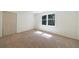 Bright bedroom with a large window letting in natural light and plush carpeting at 1348 Timberland Se Dr, Marietta, GA 30067