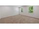 Neutral bedroom featuring carpet flooring and large windows with peaceful outdoor view at 1348 Timberland Se Dr, Marietta, GA 30067