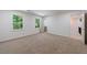 Large carpeted bedroom featuring two windows and a hallway leading to another room at 1348 Timberland Se Dr, Marietta, GA 30067