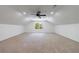 Spacious bedroom featuring neutral carpet, a ceiling fan, and a window at 1348 Timberland Se Dr, Marietta, GA 30067