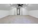 Attic bonus room features neutral carpet, fresh white paint, a ceiling fan, and access to additional rooms in the home at 1348 Timberland Se Dr, Marietta, GA 30067