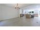 Dining room with open floor plan, chandelier, hardwood floors, and view into modern kitchen with island at 1348 Timberland Se Dr, Marietta, GA 30067