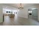 Dining room with open floor plan, chandelier, hardwood floors, and view into kitchen with island at 1348 Timberland Se Dr, Marietta, GA 30067