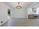 Dining room featuring chandelier, hardwood floors, and a view into the modern kitchen with stainless steel appliances at 1348 Timberland Se Dr, Marietta, GA 30067