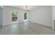 Dining room featuring chandelier and hardwood floors with a view of the surrounding trees through the windows at 1348 Timberland Se Dr, Marietta, GA 30067