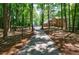 Long driveway through wooded area leading to brick home, providing seclusion and a picturesque entrance at 1348 Timberland Se Dr, Marietta, GA 30067