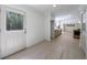 Bright entryway features a white door with sidelight, hardwood floors, and a view into the open kitchen at 1348 Timberland Se Dr, Marietta, GA 30067