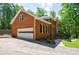 Brick home with a white garage door, landscaping, and a paved driveway at 1348 Timberland Se Dr, Marietta, GA 30067