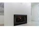 Living room fireplace with a black metal grate and white wood paneled wall at 1348 Timberland Se Dr, Marietta, GA 30067